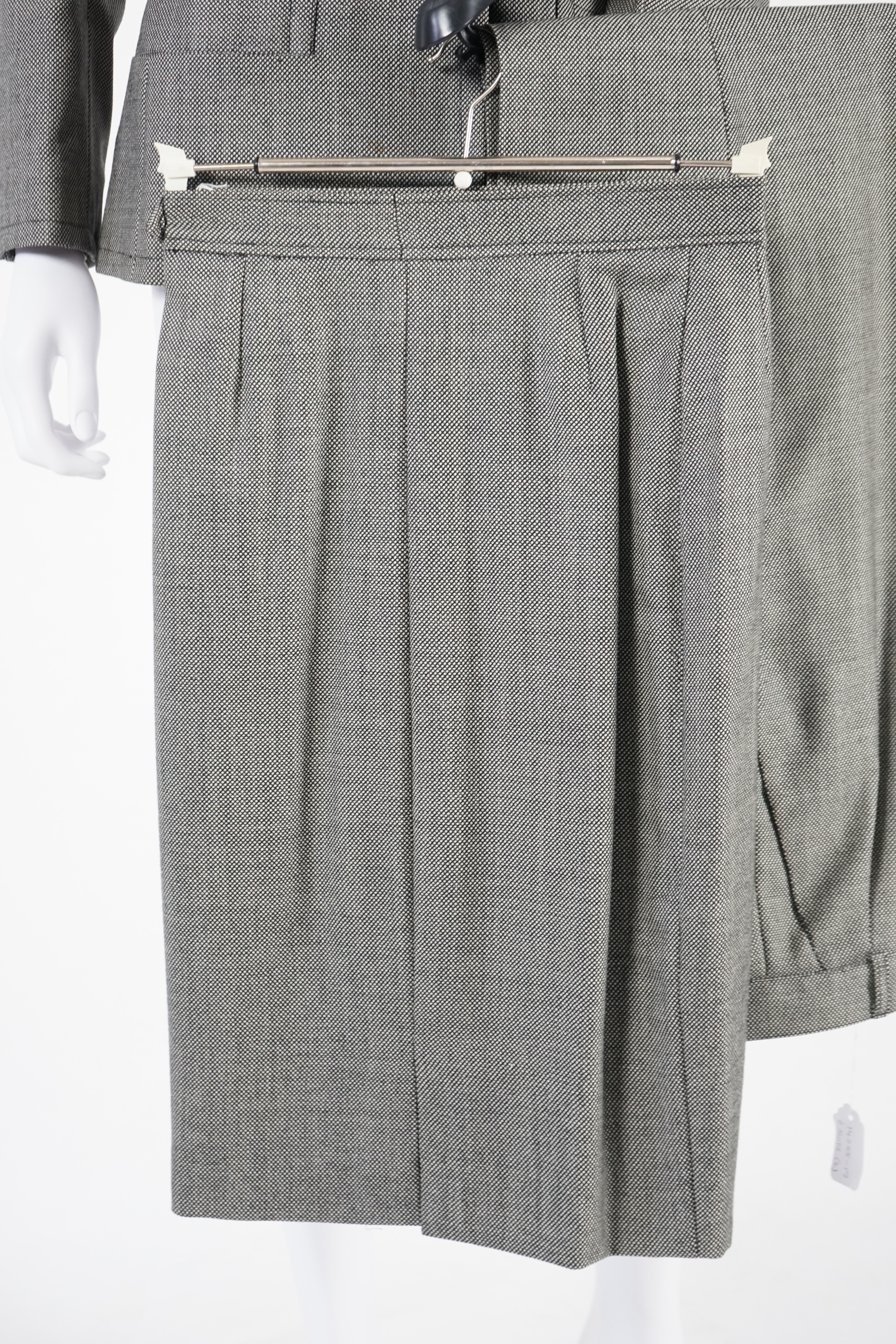 Two vintage Yves Saint Laurent variation lady's suits with matching trousers and skirts, F 40 (UK 12). Please note alterations to make the waist smaller may have been carried out on some of the skirts. Proceeds to Happy